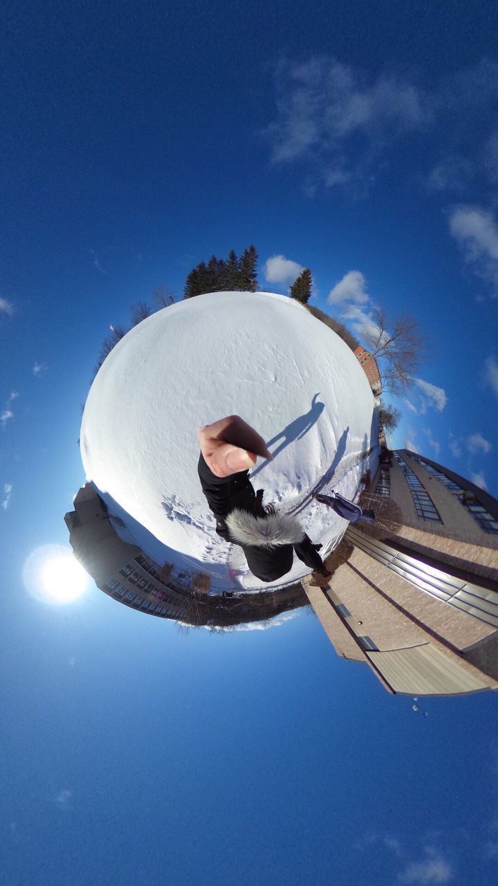 LOW ANGLE VIEW OF MAN WITH BLUE SKY