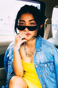 Portrait of young woman sitting outdoors