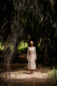 Rear view of woman standing on footpath