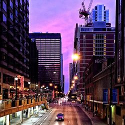 View of city street at sunset