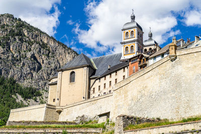 The collegiate church of notre-dame and saint-nicolas overlooking briancon city walls, france