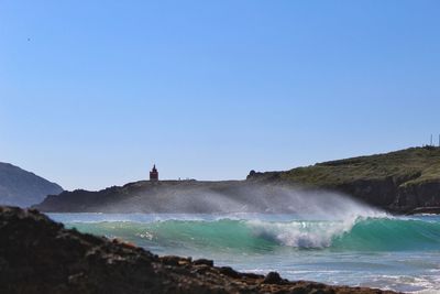 Scenic view of sea against clear blue sky
