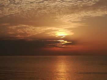 Scenic view of sea against orange sky