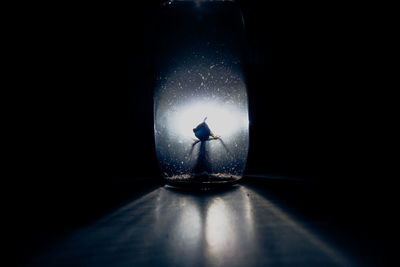 Close-up of illuminated lamp against black background