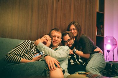 Portrait of happy family sitting at home