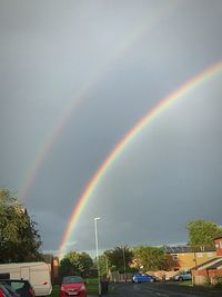 Rainbow over trees against sky