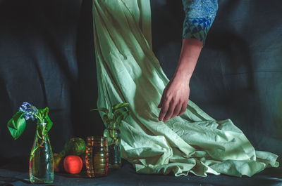 Low section of woman standing on table