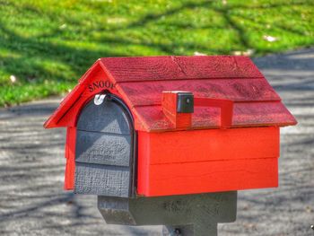 Close-up of red mailbox on rock in park