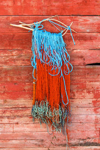 Close-up of fishing net against brick wall