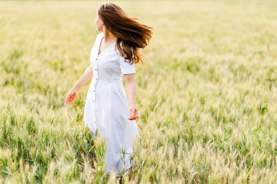 Woman with umbrella on field