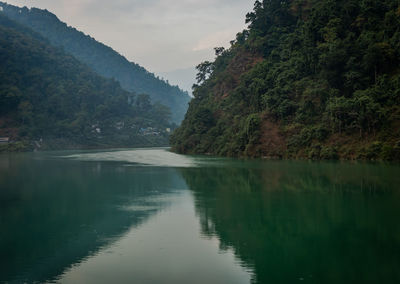Scenic view of lake in forest at morning with reflection