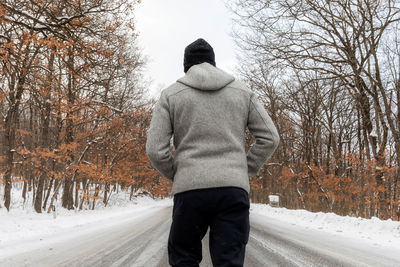 Rear view of man on snow covered land