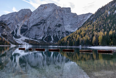 Scenic view of boats moored in lake against mountain