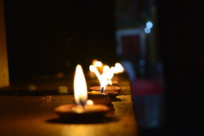 Close-up of lit candles in the dark