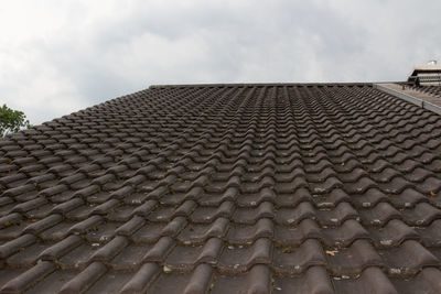 Low angle view of roof and building against sky