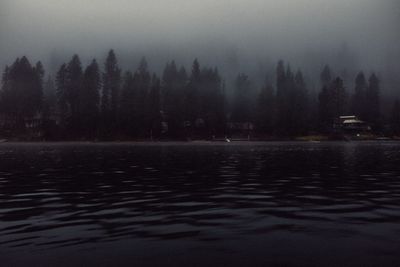 Scenic view of lake against sky at night