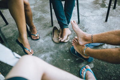 Low section of people sitting on floor