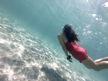 Rear view of woman swimming in sea