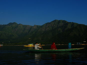 Scenic view of lake and mountains against clear sky