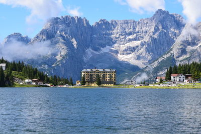 Scenic view of lake and buildings against sky