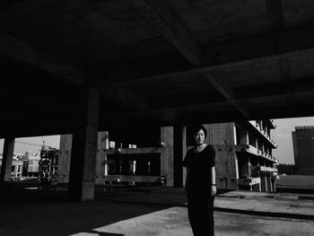 Woman standing by railing