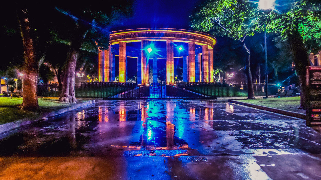 REFLECTION OF ILLUMINATED BUILDING IN WATER