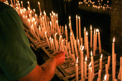 Panoramic view of lighting candles in a chapel