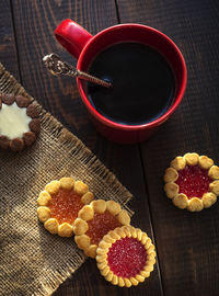 Cup of coffee and cookies on the table, top view