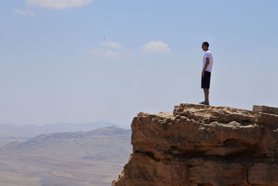 Man standing on the precipice contemplating the view