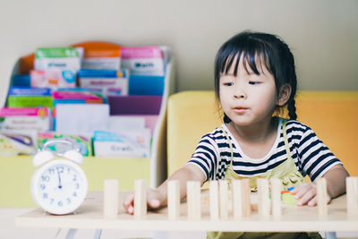 Cute girl playing with block shape at home