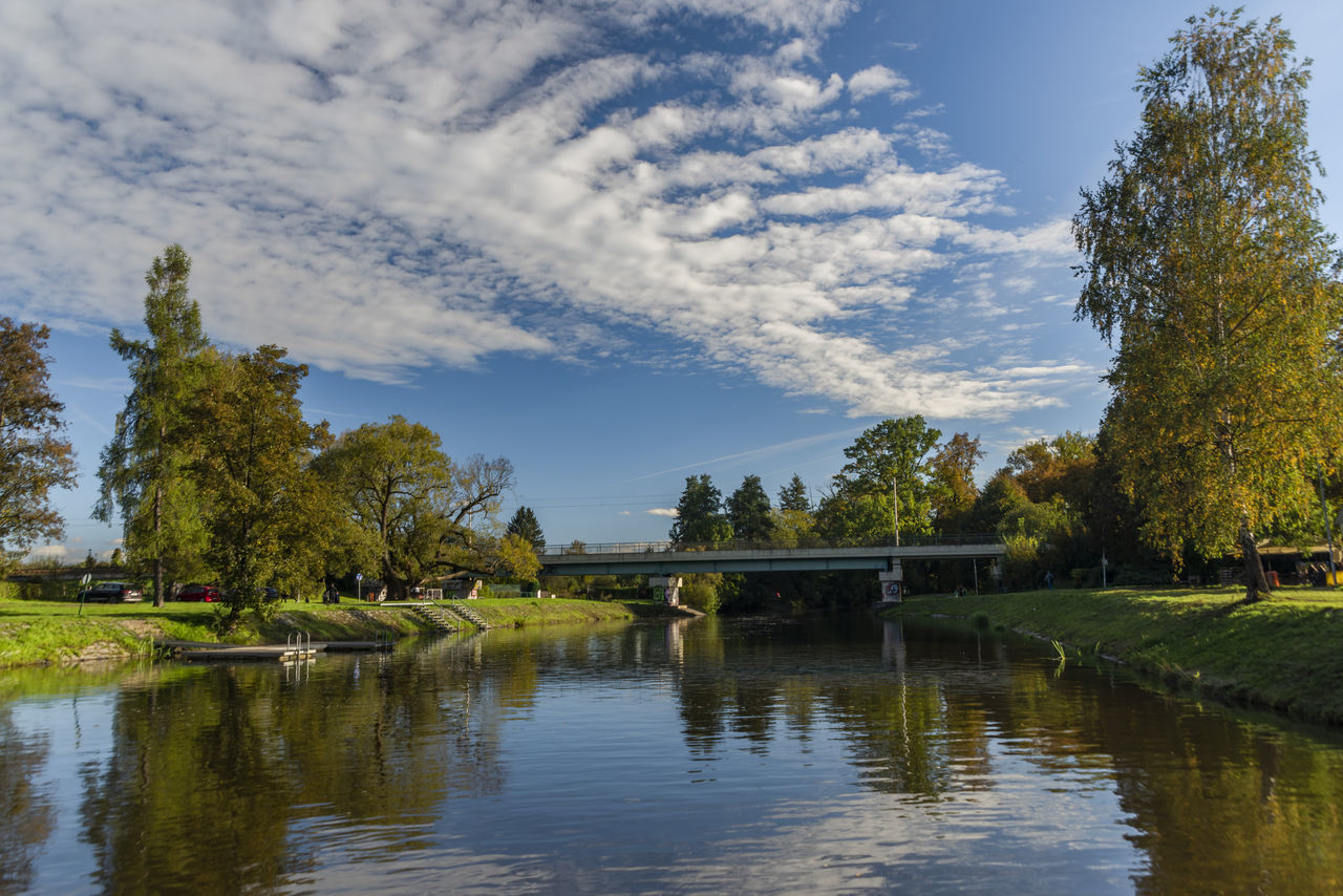 reflection, water, tree, plant, river, nature, sky, autumn, cloud, landscape, leaf, pond, beauty in nature, environment, body of water, scenics - nature, tranquility, architecture, no people, travel destinations, travel, rural area, tourism, outdoors, tranquil scene, built structure, waterway, morning, grass, reservoir, day, flower, land