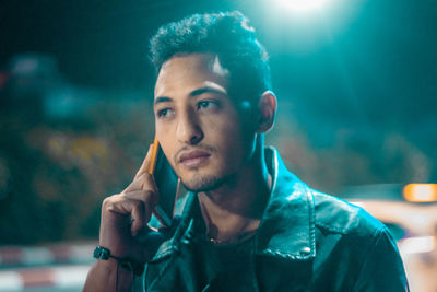 Close-up portrait of young man smoking outdoors