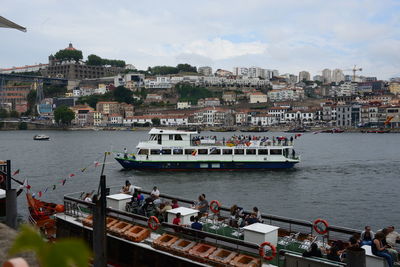 High angle view of boats in river against buildings