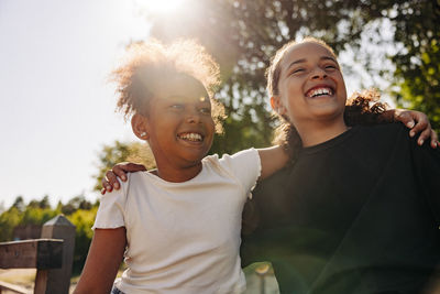 Happy female friends enjoying together at summer camp