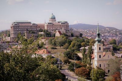 Buildings in town against sky