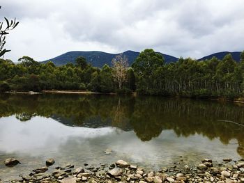 Scenic view of lake and mountains against sky