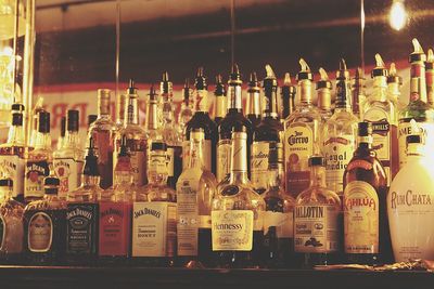 Panoramic shot of glass bottles on display