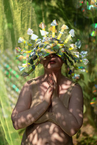 Portrait a woman in a reflective mask in a beige bikini on a cd / dvd case of scenery in the forest