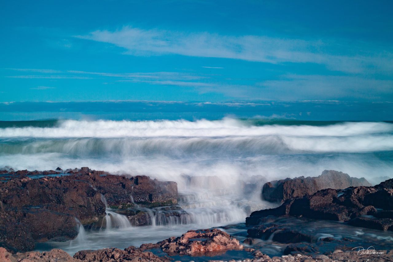 SCENIC VIEW OF SEA AGAINST ROCKS