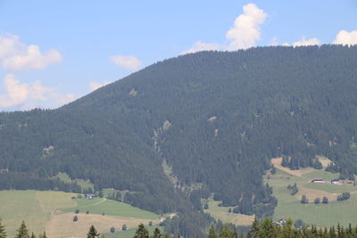 Scenic view of field and mountains against sky