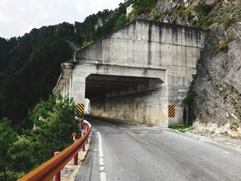 Road by bridge against sky