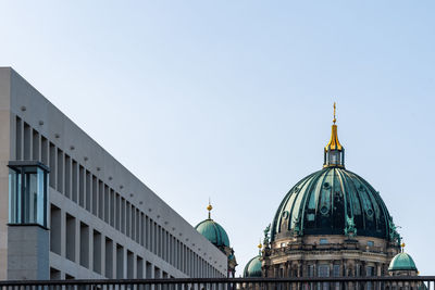 Low angle view of the dome of berlin cathedral from spree river, berliner dom against blue sky