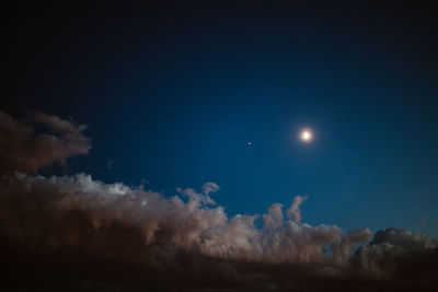 Low angle view of moon in sky at night