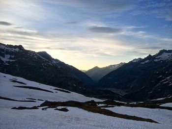 Scenic view of snowcapped mountains against sky during sunset