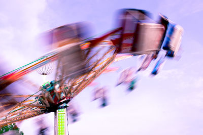 Low angle view of blurred motion of building against sky