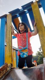Full length of girl standing against the sky