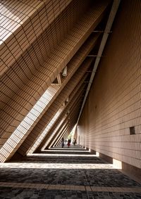 People walking in corridor of building