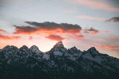 Scenic view of snowcapped mountains against sky during sunset