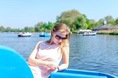 Woman sitting in boat over lake