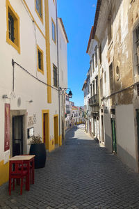 Empty alley amidst buildings in city